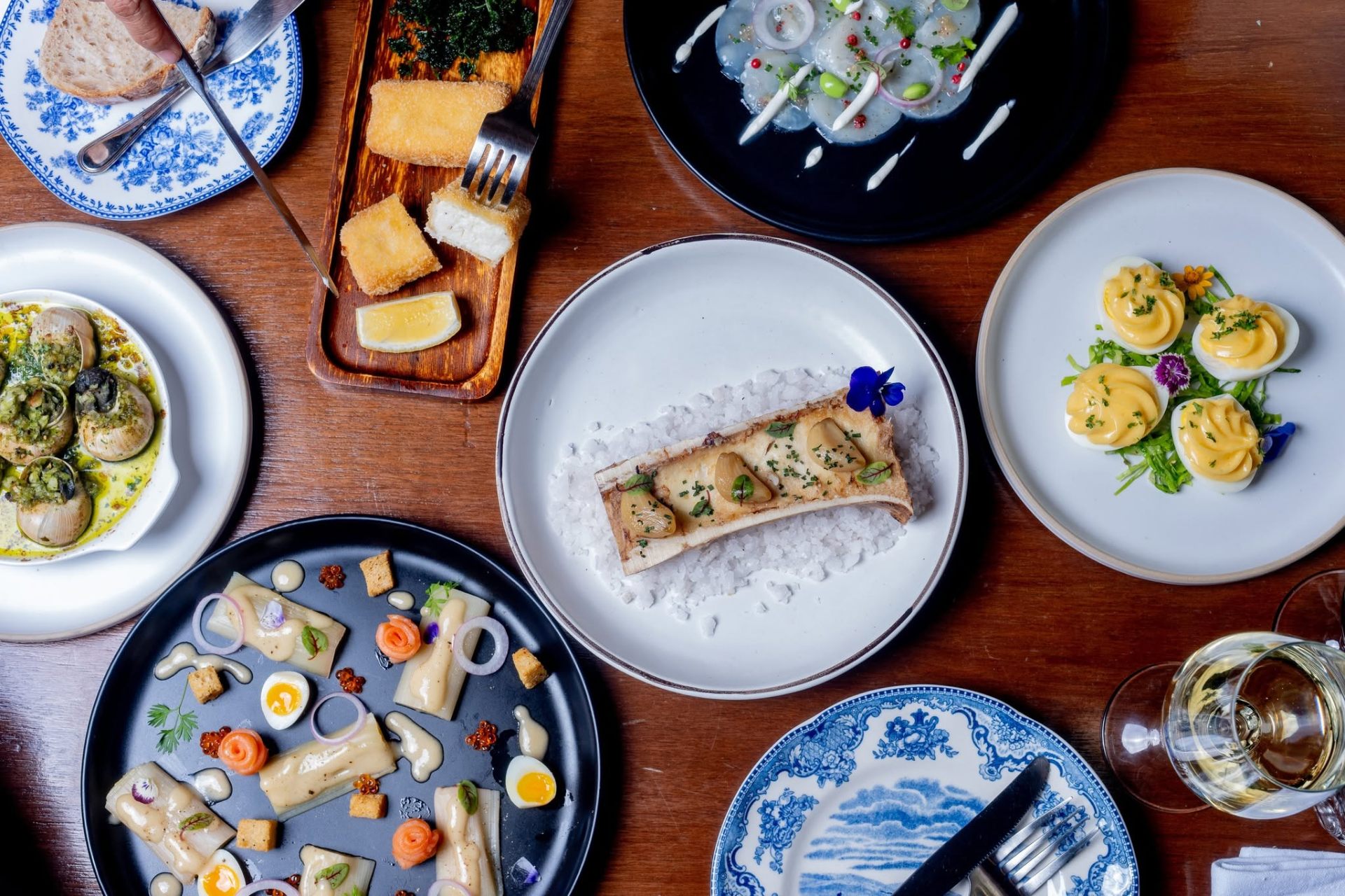 A spread of French bistro dishes at LA PLANTE